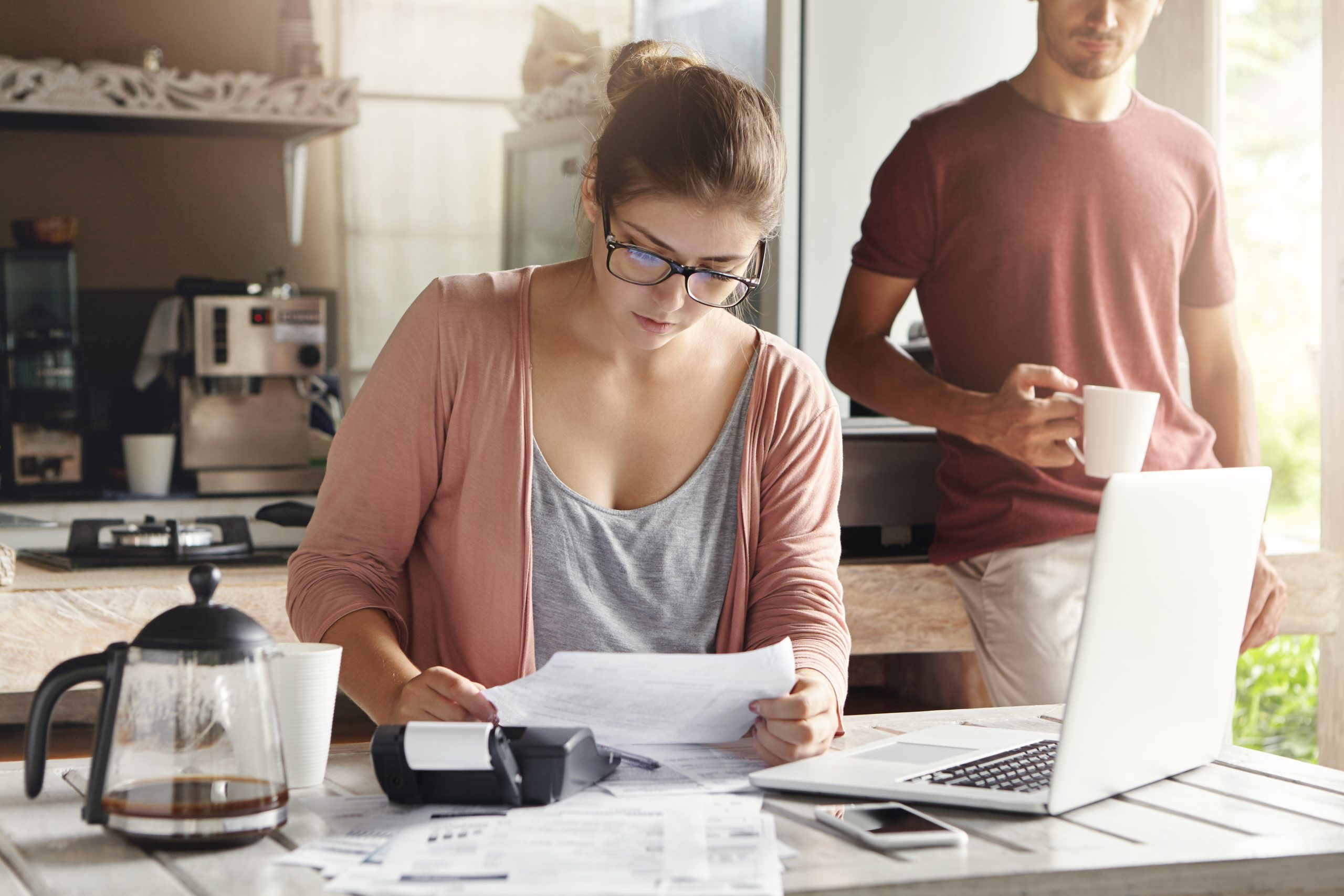 family budget finances young woman doing accounts together with her husband home planning new purchase serious female glasses holding piece paper making necessary calculations scaled - Engineering Wealth - shubhamsxn